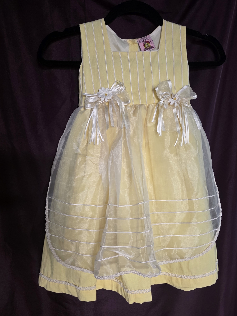 Angelica's yellow "match my doll" dress with white vertical stripes.